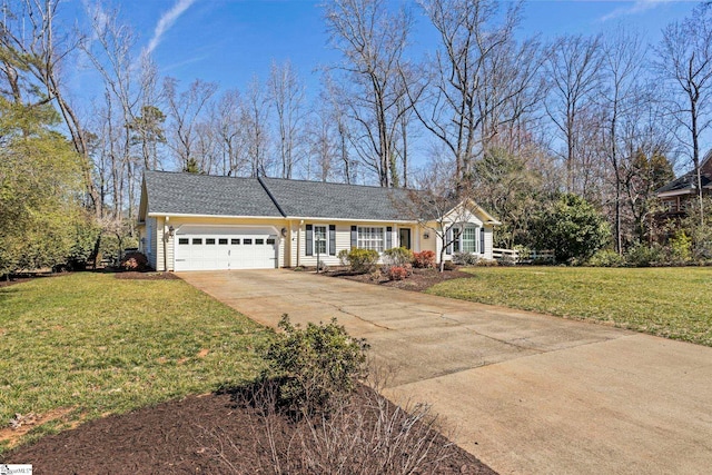 ranch-style home featuring an attached garage, driveway, and a front lawn