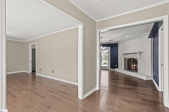 hallway with an inviting chandelier, ornamental molding, and wood finished floors