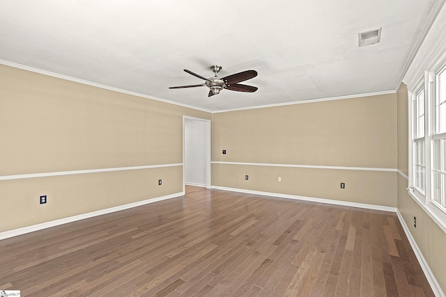 spare room with crown molding, visible vents, ceiling fan, and wood finished floors