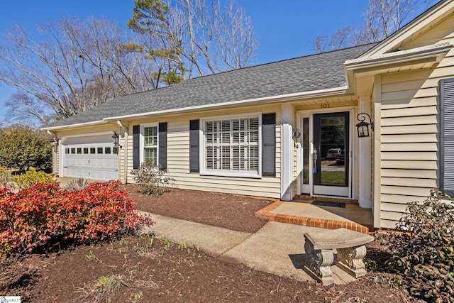 property entrance featuring a garage and a shingled roof