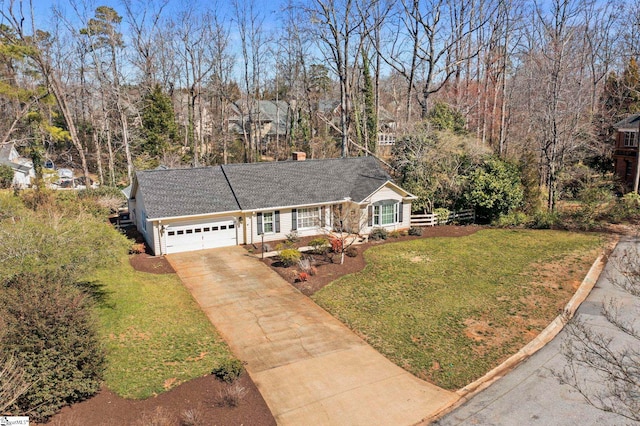 single story home with a garage, a front yard, and driveway