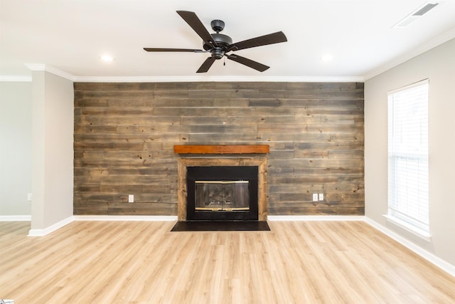 details with visible vents, ornamental molding, wood finished floors, and a fireplace with flush hearth