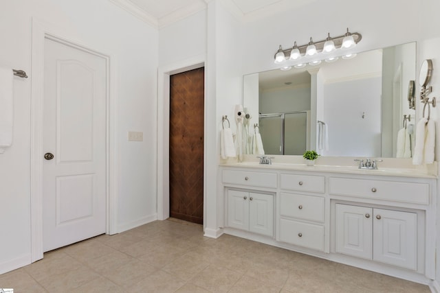 full bath featuring double vanity, a stall shower, tile patterned flooring, crown molding, and a sink