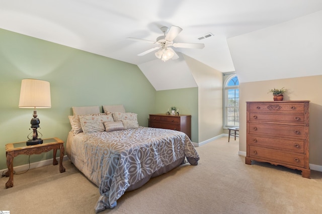 carpeted bedroom with visible vents, vaulted ceiling, baseboards, and ceiling fan