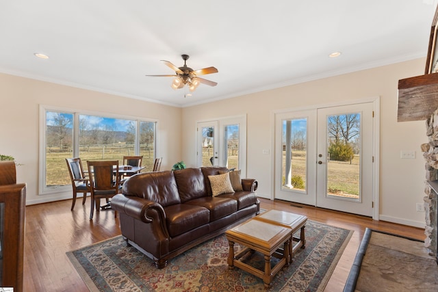 living room with ornamental molding, french doors, baseboards, and wood finished floors