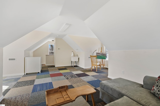 bonus room featuring visible vents, vaulted ceiling, and baseboards