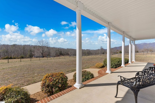 view of patio featuring a porch and a rural view