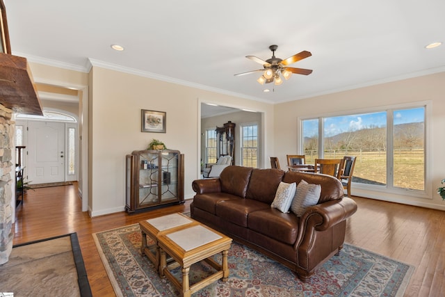 living room with baseboards, ceiling fan, ornamental molding, wood finished floors, and recessed lighting