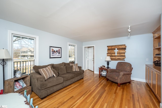 living room featuring baseboards and light wood-style floors