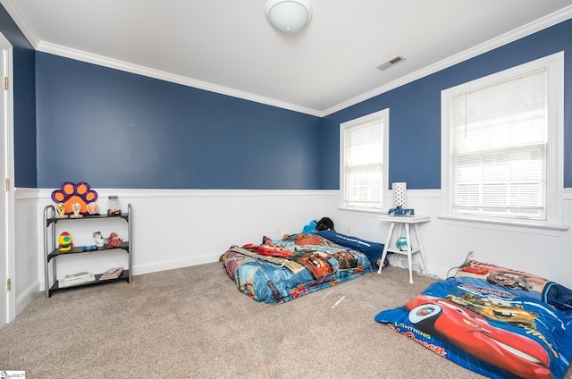 bedroom featuring visible vents, crown molding, and carpet flooring