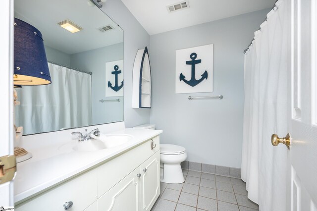 full bath with visible vents, vanity, toilet, and tile patterned floors