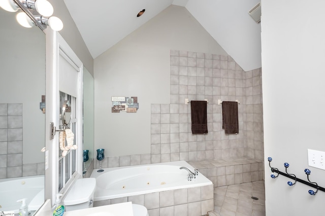 bathroom with vaulted ceiling and a whirlpool tub