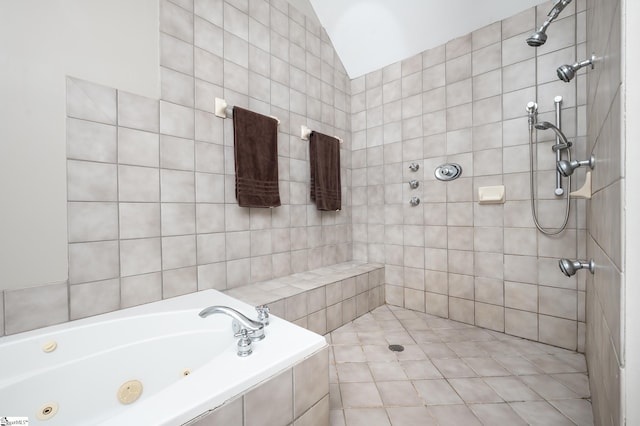 bathroom with tiled shower, tile walls, and a tub with jets