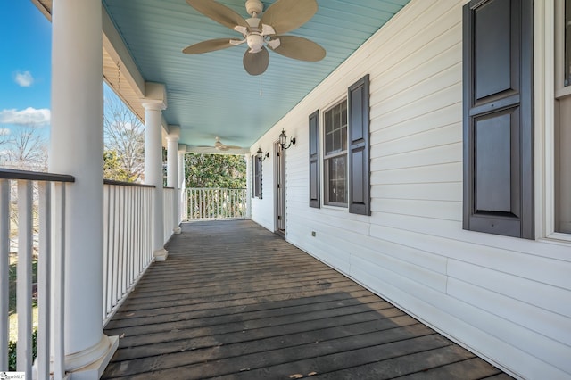 wooden deck with covered porch and ceiling fan