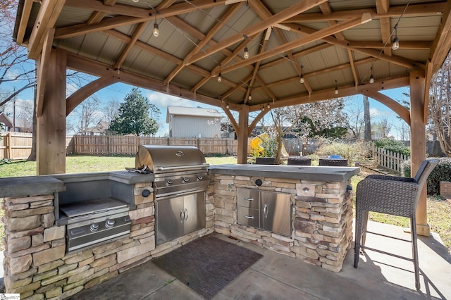 view of patio / terrace with a fenced backyard, area for grilling, and a gazebo