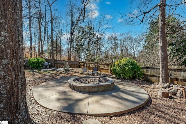 view of patio / terrace featuring an outdoor fire pit and a fenced backyard