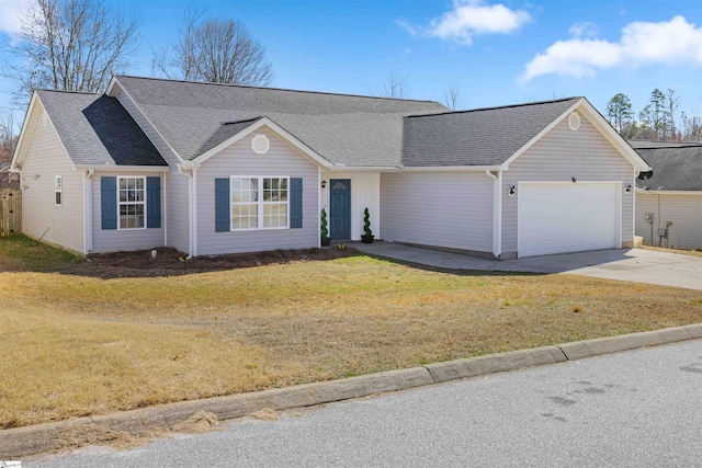 ranch-style home with driveway, an attached garage, roof with shingles, and a front yard