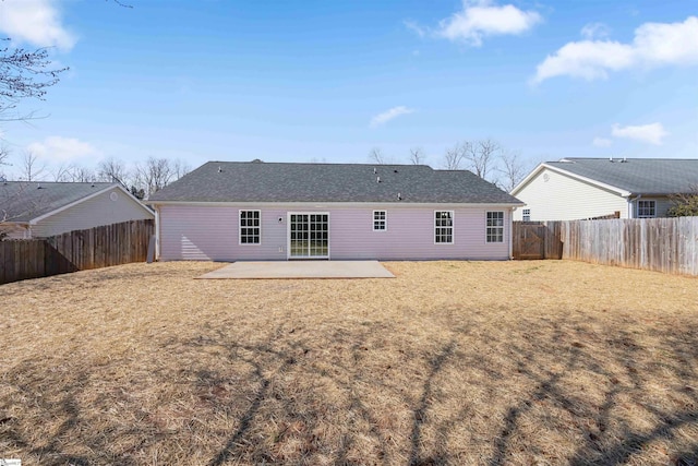 back of property featuring a fenced backyard, a lawn, and a patio