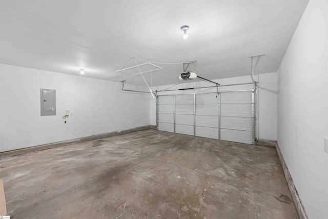 garage with a garage door opener, electric panel, and baseboards