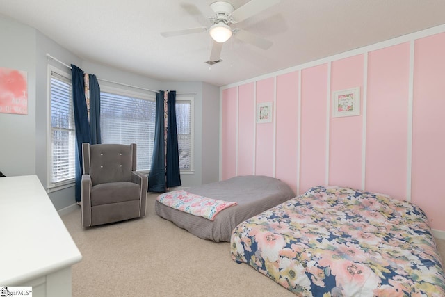 bedroom featuring a ceiling fan, visible vents, and carpet flooring