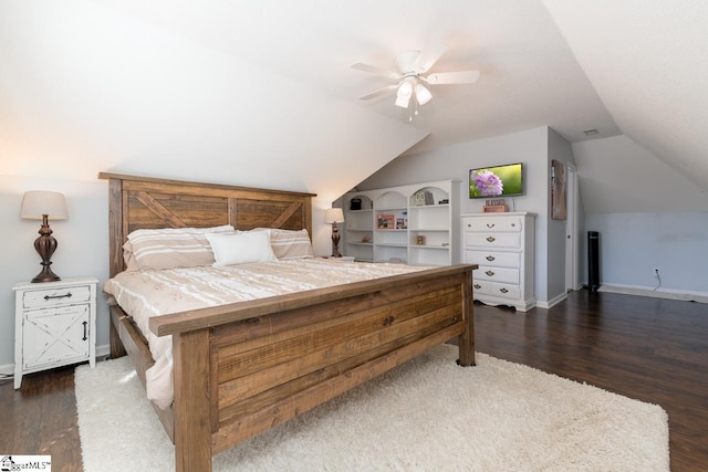 bedroom with dark wood-style floors, lofted ceiling, baseboards, and a ceiling fan