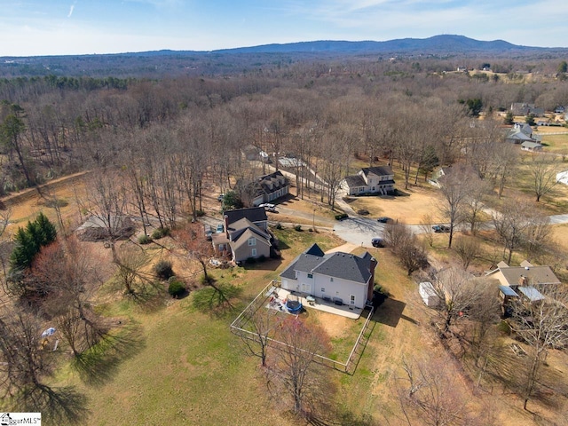 birds eye view of property with a mountain view and a view of trees