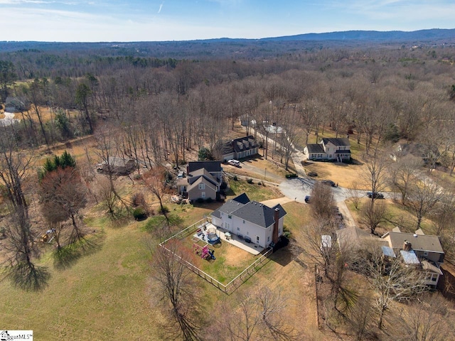 aerial view featuring a mountain view and a wooded view