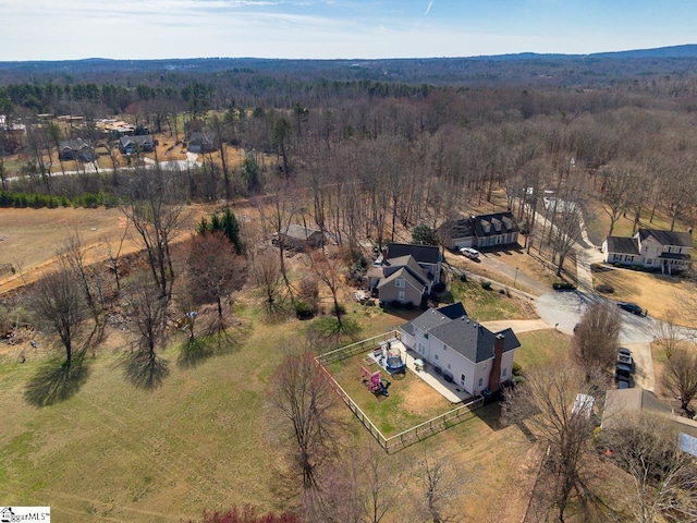 drone / aerial view featuring a wooded view