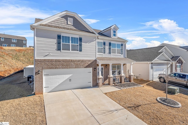 view of front of property with a porch, brick siding, driveway, and an attached garage