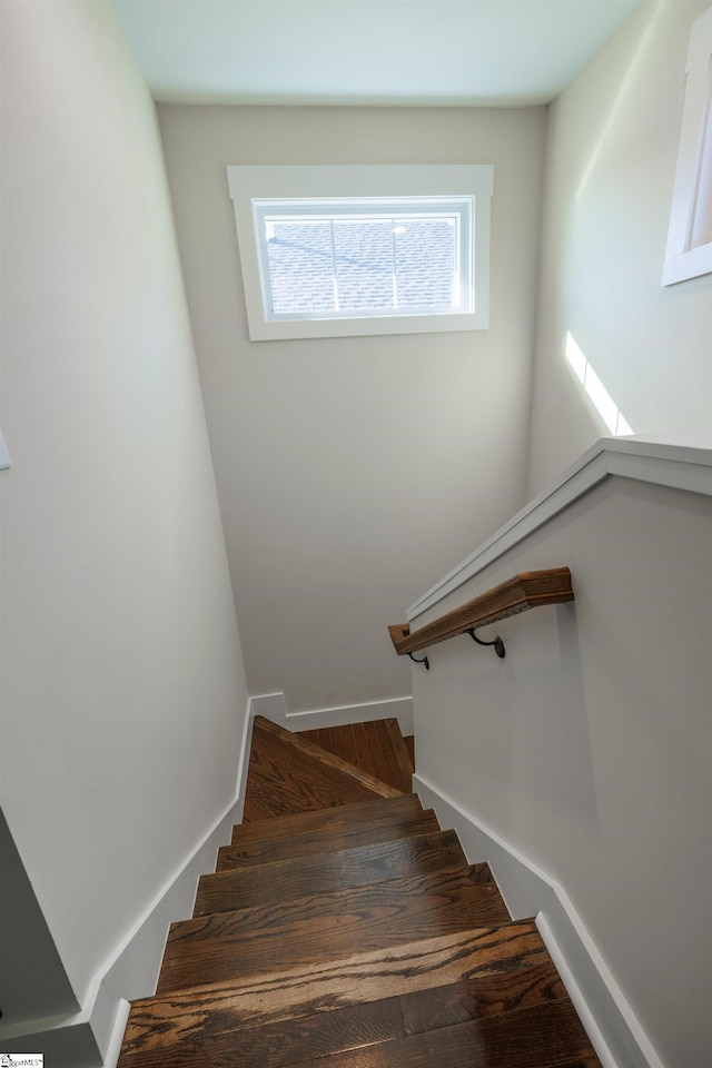 stairs with baseboards and wood finished floors