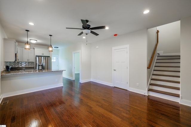 unfurnished living room with baseboards, a ceiling fan, dark wood-style flooring, stairs, and recessed lighting