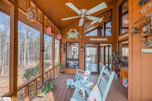 sunroom / solarium with ceiling fan, lofted ceiling, and a healthy amount of sunlight