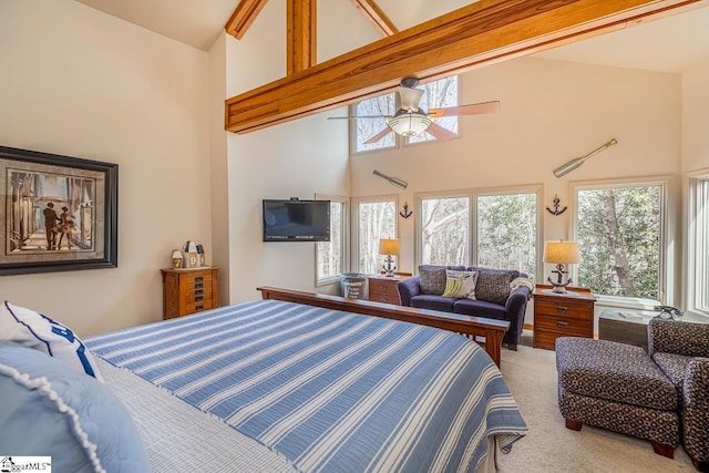 carpeted bedroom featuring ceiling fan, high vaulted ceiling, and multiple windows