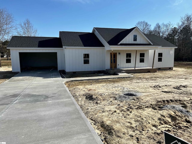 modern farmhouse style home featuring a garage, driveway, crawl space, and roof with shingles