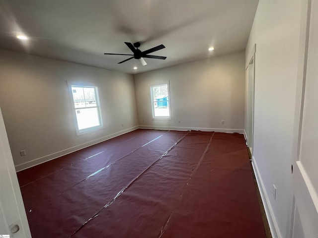 spare room with recessed lighting, a ceiling fan, and baseboards