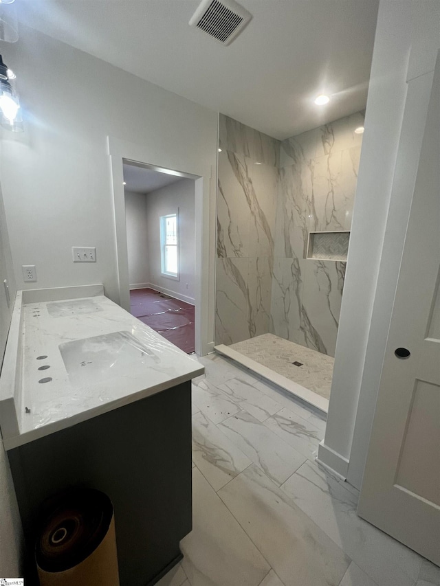 full bath with a marble finish shower, baseboards, visible vents, marble finish floor, and vanity