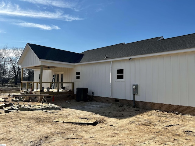 back of house with a shingled roof, crawl space, ceiling fan, and french doors