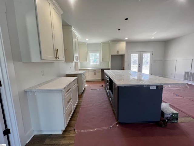 kitchen with visible vents, dark wood-style floors, a kitchen island, french doors, and recessed lighting