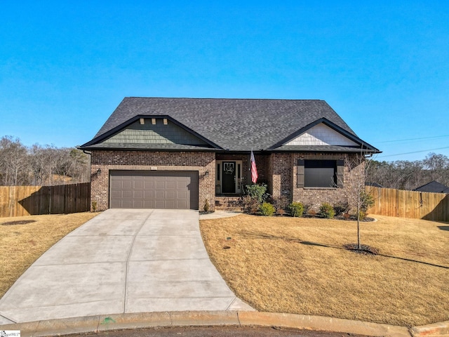 craftsman inspired home with an attached garage, driveway, a front lawn, and fence