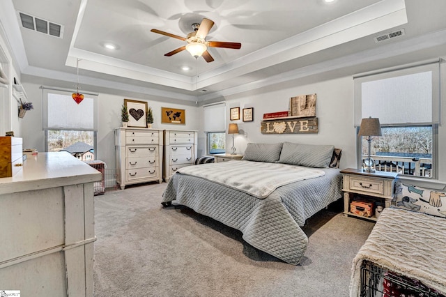 bedroom featuring carpet, visible vents, a tray ceiling, and recessed lighting