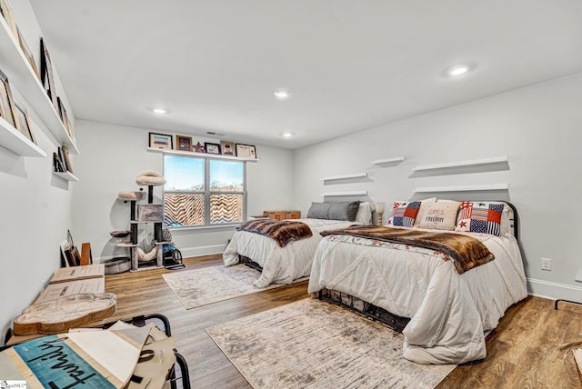 bedroom featuring recessed lighting, baseboards, and wood finished floors