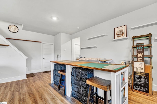 kitchen featuring light wood-style flooring and baseboards