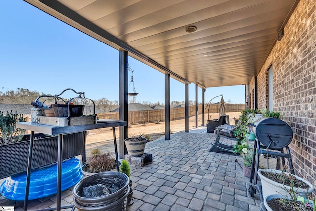 view of patio with a trampoline and a fenced backyard