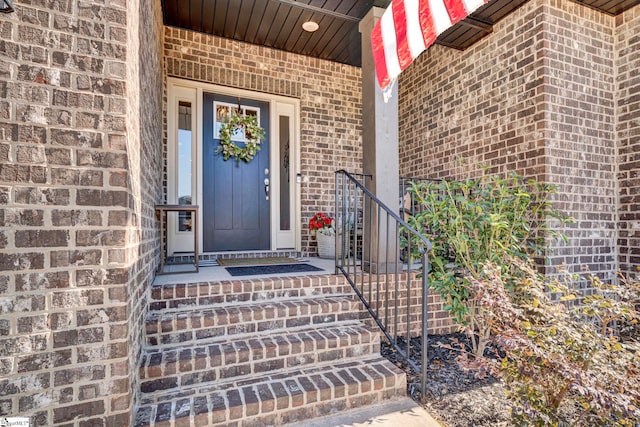 property entrance featuring brick siding