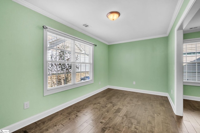 unfurnished room with ornamental molding, visible vents, dark wood finished floors, and baseboards