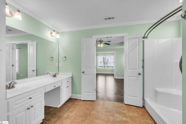 bathroom with double vanity, ornamental molding, a sink, and visible vents