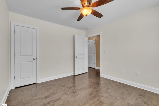 unfurnished bedroom featuring a ceiling fan, baseboards, and wood finished floors