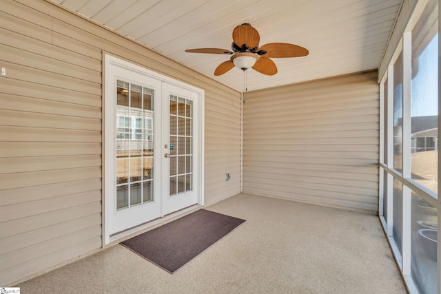 unfurnished sunroom featuring a ceiling fan