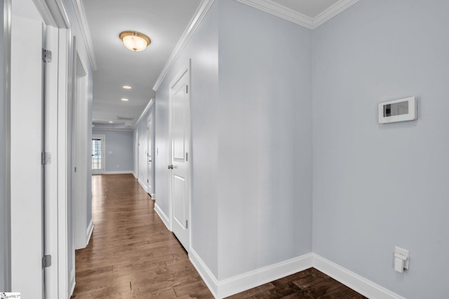 hallway featuring baseboards, ornamental molding, wood finished floors, and recessed lighting