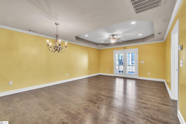 spare room featuring french doors, a tray ceiling, and visible vents